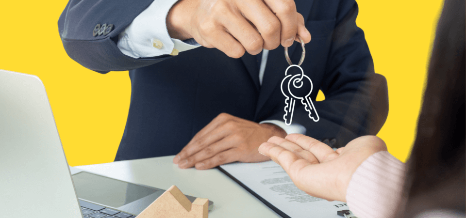 Man handing another person a set of keys