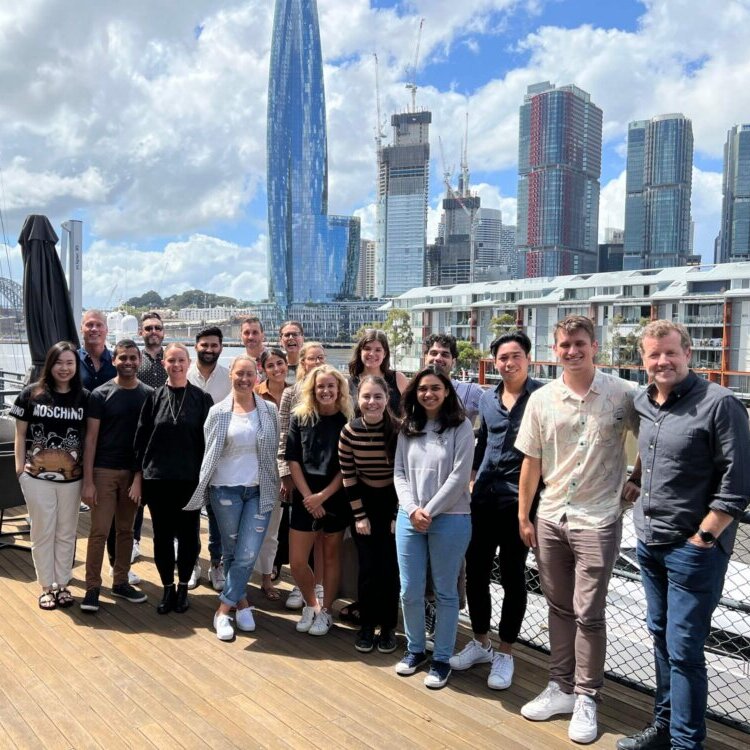 A photo of Frontier Australia Employees standing in front of the Sydney Skyline