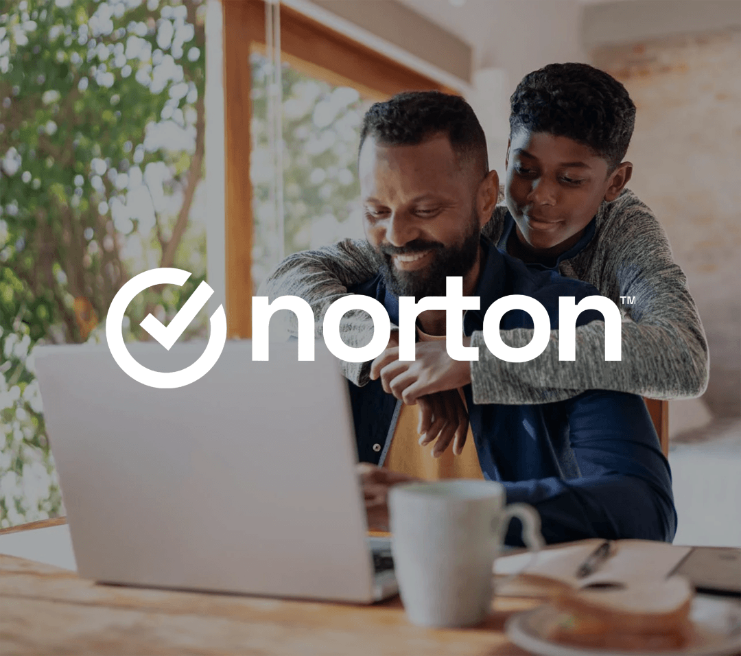Father and son smiling and looking at laptop